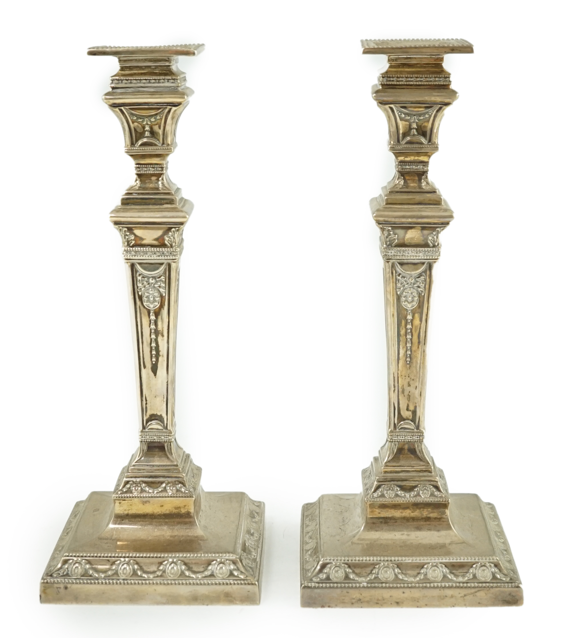 A pair of Edwardian Adam revival silver candlesticks, by Walker & Hall